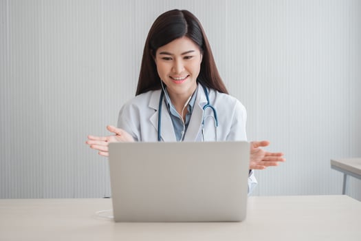 Asian therapist woman doctor is online visiting with a patient on the internet application. Her Listening and Give advice and explains how to treat the initial disease, Concept of Medical technology. photo