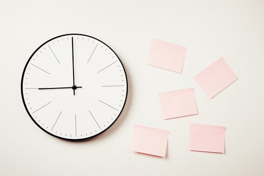 Wall clock and pink stickers on a white background. Workspace mock up photo