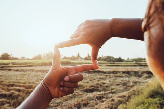 close up woman make hand framing gesture distant view. business concept photo