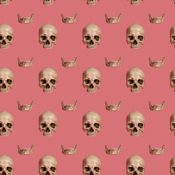 Skull with jaw on a pink seamless pattern. photo