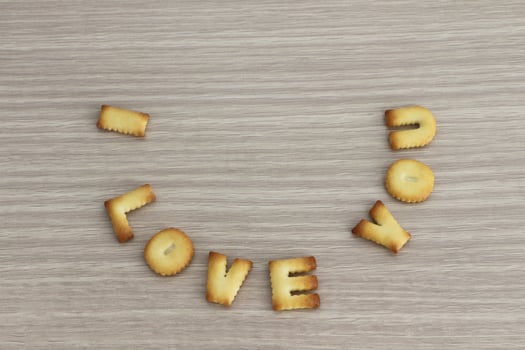 I LOVE YOU sentence arranged with cookies ABC on white oak wooden background for valentine's day. photo