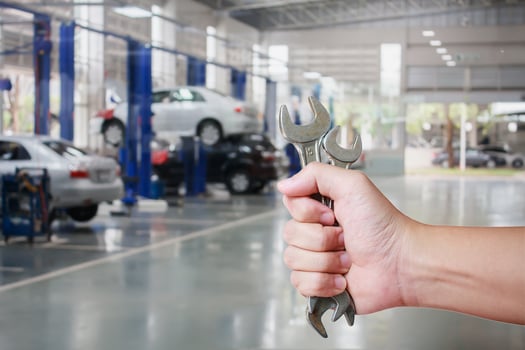 Hand of professional Auto mechanic with wrench photo