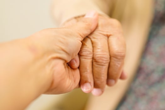 Caregiver holding hands Asian elderly woman patient, help and care in hospital. photo
