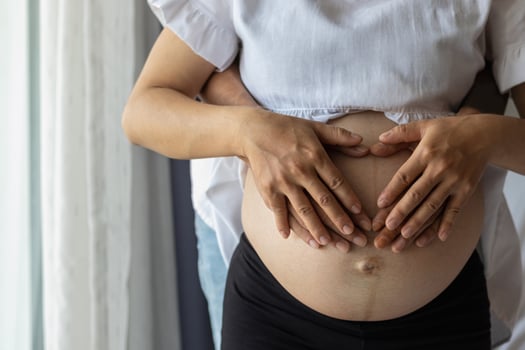 Smooth Focus, A pregnancy woman and her boyfriend put their hands on the womb to show their love for the unborn child. Love concept of a pregnancy woman and her lover towards the unborn child. photo