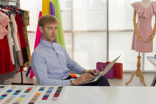 Professional male sewing designers in the office have a variety of fabric color schemes. photo