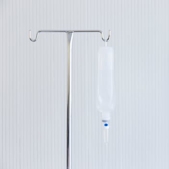 Saline jar hanging in a steel pole in the hospital. photo