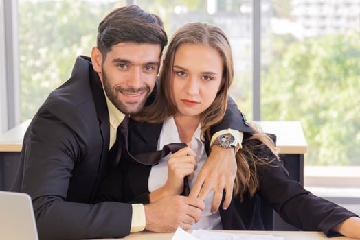 Two young businessmen, men and women, work at the office with a tablet and accompanying documents on the desk with smiles and happiness. photo
