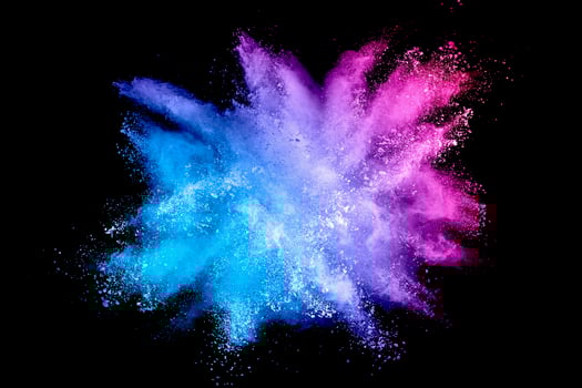 Colorful background of pastel powder explosion.Multi colored dust splash on black background.Painted Holi. photo