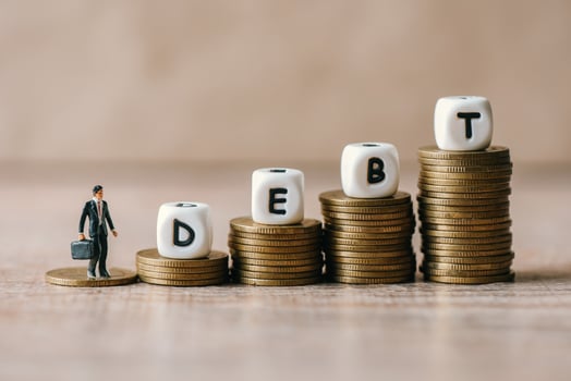 Block word debt on pile of coins with business man, Payment of taxes and of debt to the state, Concept of financial crisis and problems risk management debt exemption loan photo