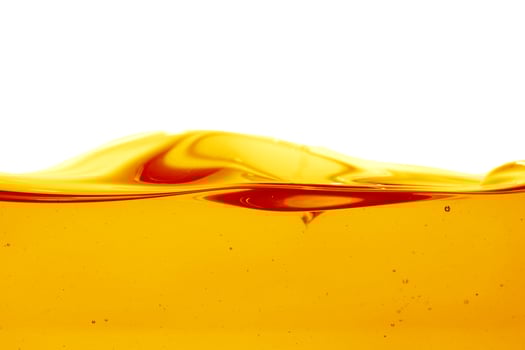 Wave of oil viscosity and air bubbles inside oil isolated on white background. photo