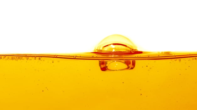 Wave of oil viscosity and air bubbles inside oil isolated on white background. photo