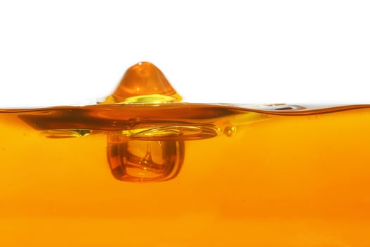 Wave of oil viscosity and air bubbles inside oil isolated on white background. photo