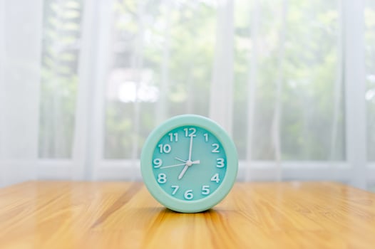 Light green alarm clock Placed on the table in the bedroom photo