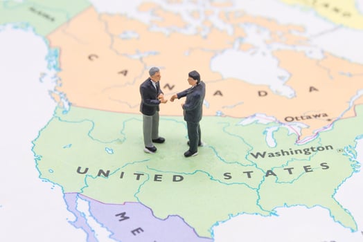 Miniature people, businessman standing on map American photo