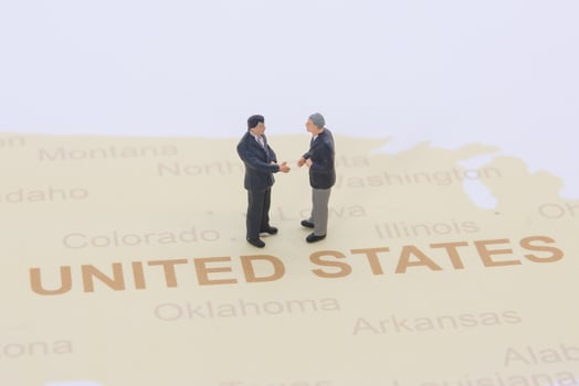 Miniature people, businessman standing on map American photo