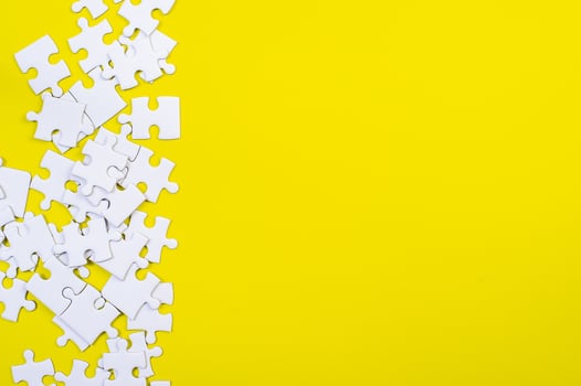 Jigsaw puzzles on the yellow background photo