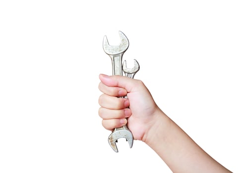 hand holding wrench isolated on white background photo