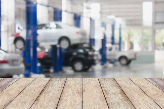 Wood table top with blur garage background photo