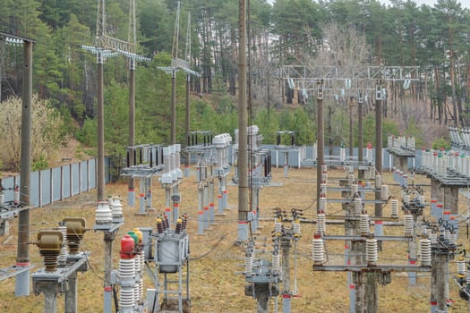 Railway high-voltage electrical substation in a coniferous forest. photo