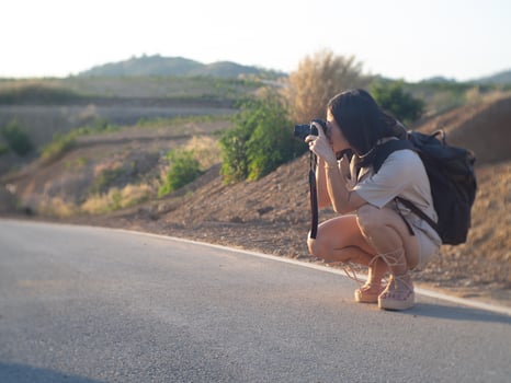 woman on road and camera photo