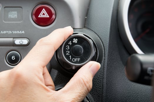 man turning car air conditioner switch photo
