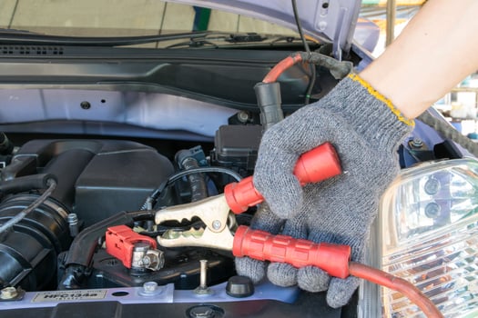 automotive technician charging vehicle battery photo