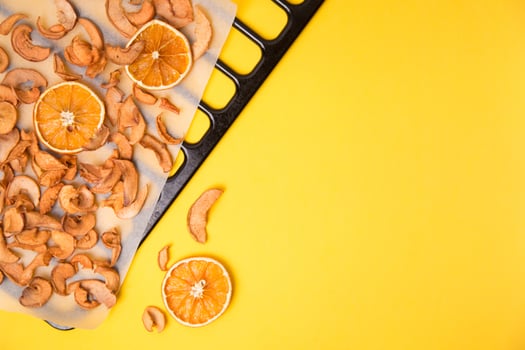Homemade dried organic apple sliced on yellow background. photo