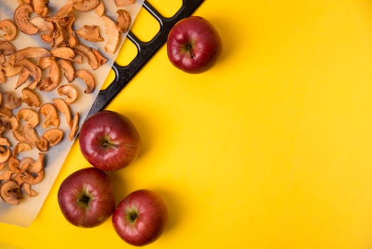 Homemade dried organic apple sliced on yellow background. photo