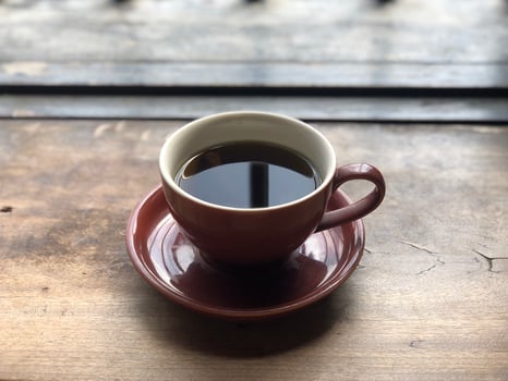 Hot coffee cup on wooden table photo