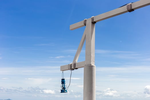 White wooden pole with lanterns hanging in a bright sky background. photo