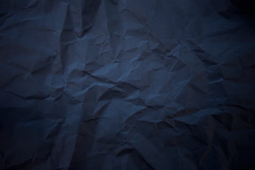 Textured crumpled black paper background. photo