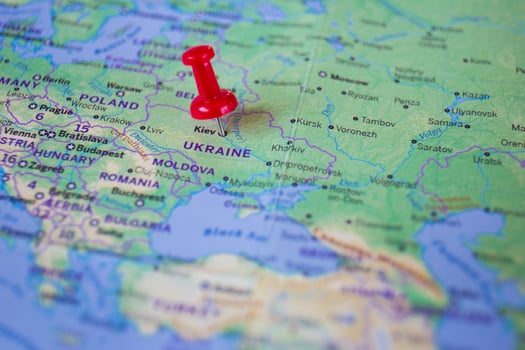 A red pin embroidered on the world map of Ukraine, the city of Kiev. photo