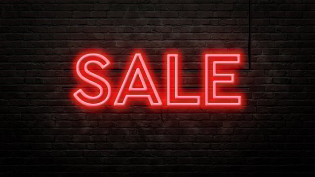 sale neon sign emblem in neon style on brick wall background photo