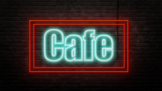 cafe neon sign emblem in neon style on brick wall background photo
