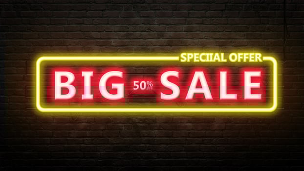 BIG SALE sign emblem in neon style on brick wall background photo