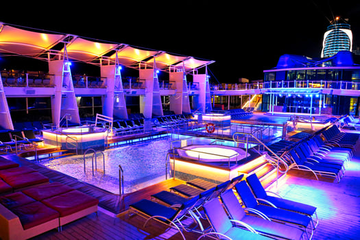 Cruise ship swimming pool at night on the top deck with scenic views photo