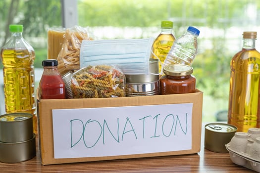 Foodstuff for donation, storage and delivery. Various food, pasta, cooking oil and canned food in cardboard box. photo