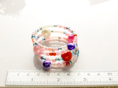 Multi-colored bracelets with beads. Colourful child's bead bracelet. photo