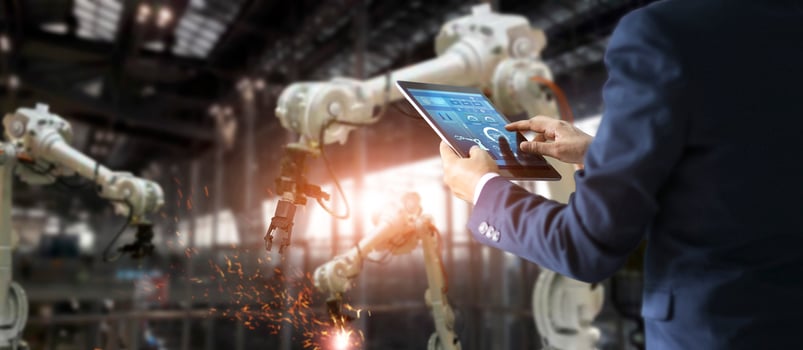 Manager industrial engineer using tablet check and control automation robot arms machine in intelligent factory industrial on software. Welding roboticts and digital manufacturing operation. photo