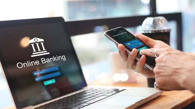 Man using online banking with credit card on touch screen device. Digital and internet payments.Bank login on a laptop screen. All on screen and credit card are design up. photo