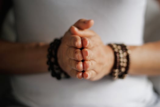 Woman hand yoga pose. Practicing meditation and praying indoors. photo
