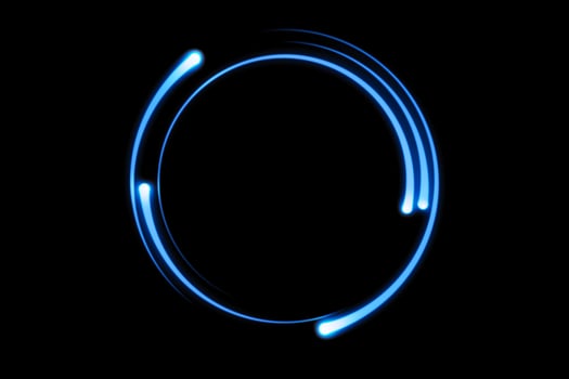 Blue fire comet light flying in circle. Shining lights in motion with particles on black sky. Ring of fire, abstract background photo