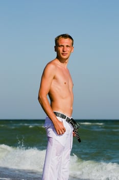 a man walking along the seashore photo