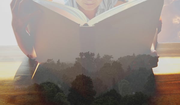 Young lady reading a book about mysteries of the world photo