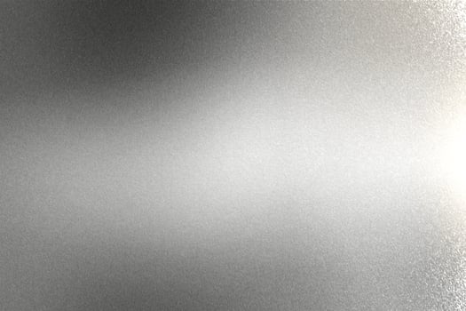 Light shining on brushed silver metal wall texture, abstract background photo