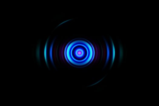 Abstract glowing circle blue light effect on black background photo