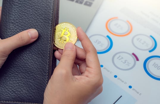 Businessman holding bitcoin coins out of wallet. Virtual currency. Crypto currency. New virtual money. photo