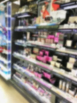 blurred beauty and cosmetics shelves in supermarket photo