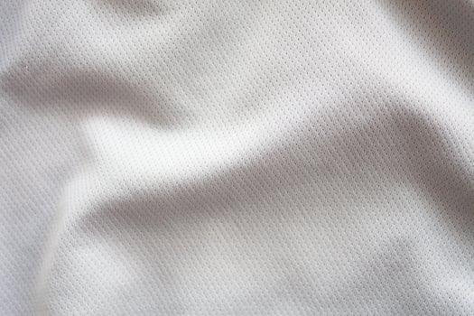 Close up shot of white textured football jersey photo