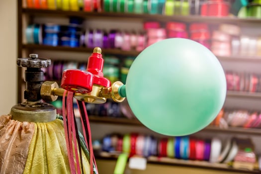 inflates the balloon with helium photo